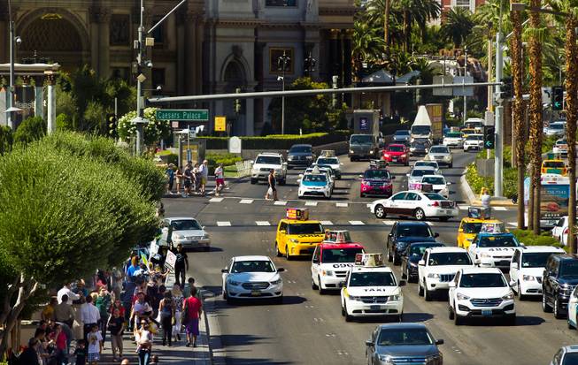 Taxi cab drivers gather Friday, May 29, 2015, in front of Caesars Palace to protest Uber, the ride-hailing service trying to break into the Las Vegas market. 