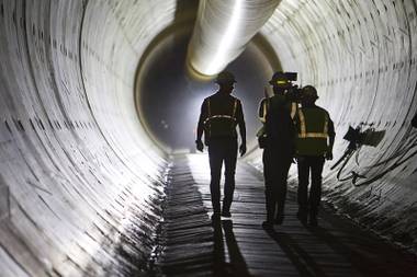 Claudio Cimiotti, left, senior tunnel engineer, walks with a news crew during a tour of the third intake tunnel under Lake Mead Monday, June 1, 2015.