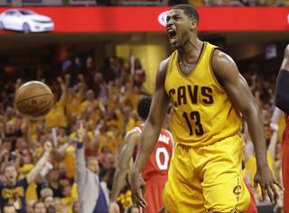 Cleveland Cavaliers center Tristan Thompson (13) reacts after dunking the ball against the Atlanta Hawks in the second half of Game 4 of the NBA basketball Eastern Conference Finals, Tuesday, May 26, 2015, in Cleveland. 