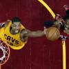Cleveland Cavaliers' Tristan Thompson, right, and Atlanta Hawks' DeMarre Carroll battle for a loose ball in the second half of Game 4 of the NBA basketball Eastern Conference Finals, Tuesday, May 26, 2015, in Cleveland. The Cavaliers defeated the Hawks 118-88. 