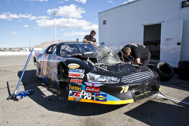 Crew members work on Chris Trickle's car May 16, 2015, at the Bullring at Las Vegas Motor Speedway.