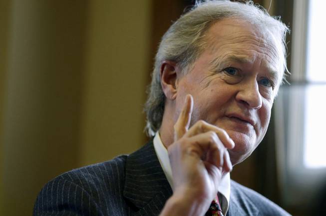 In this Dec. 11, 2014, file photo, then-Rhode Island Gov. Lincoln Chafee responds to questions during an interview with The Associated Press in his office at the Statehouse, in Providence, R.I.