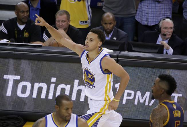 Golden State Warriors guard Stephen Curry (30) reacts during the second half of Game 1 of basketball's NBA Finals against the Cleveland Cavaliers in Oakland, Calif., Thursday, June 4, 2015. 