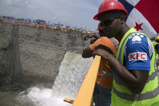 A canal worker looks over a railing as water from the Atlantic begins to flood the Gatun flood chambers that will provide water to the new set of locks in the Atlantic side of the Panama Canal in Colon, Panama, Thursday, June 11, 2015. Water began flooding into an expanded section of the Panama Canal as engineers begin testing new locks. It’s a key step in a project that will affect trade across the world. 