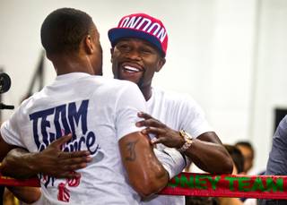 Boxer Errol Spence Jr., gets a hug from Floyd Mayweather after a workout in the ring at the Mayweather Boxing Club on Tuesday, June 16, 2015.
