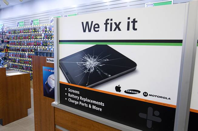 A sign advertises repair services for electronics in the Batteries Plus Bulbs store, 2546 E Craig Road, in North Las Vegas Monday, June 22, 2015.