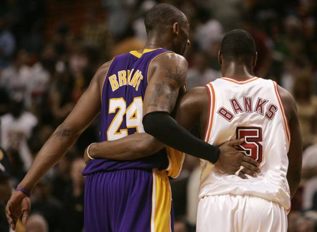 Los Angeles Lakers guard Kobe Bryant (24) and Miami Heat guard Marcus Banks (5) walk off the court following a Lakers 104-94 victory during a basketball game in Miami, Sunday, Feb. 10, 2008. Banks scored seven points in his debut with the Heat after a trade with the Phoenix Suns.