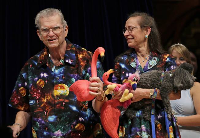In this Thursday, Sept. 20, 2012, photo artist Don Featherstone, creator of the plastic pink flamingo lawn ornament, poses with his wife, Nancy.