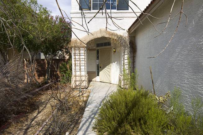 The entryway to a foreclosed home is shown in a neighborhood near Tenaya Way and Russell Road Thursday, June 25, 2015.
