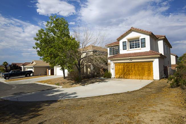 A foreclosed home is shown in a neighborhood near Tenaya Way and Russell Road Thursday, June 25, 2015.