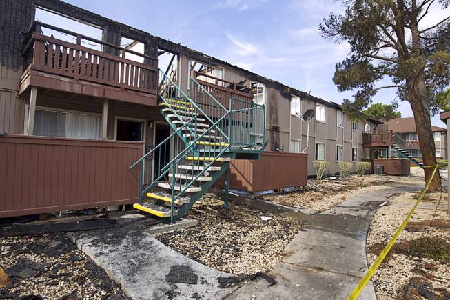 An apartment unit is shown after an early morning three-alarm fire at the Sandpebble Village apartments at Arville Street and Sirius Avenue Sunday, June 28, 2015.
