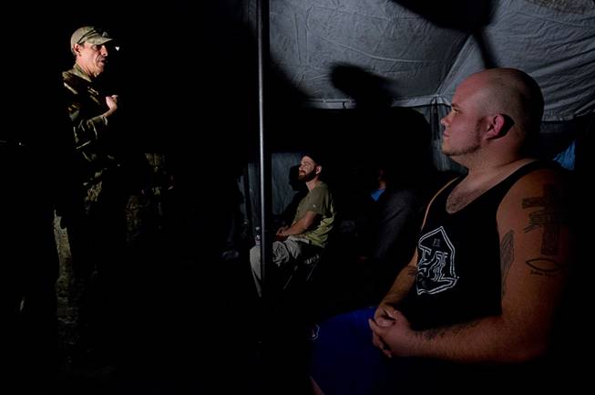 Team leader Wambat, left, gives a briefing before an operation at Adventure Combat Ops, 4375 S. Valley View Blvd., Monday, June 29, 2015. The zombie-apocalypse-combat experience opens on July 2.