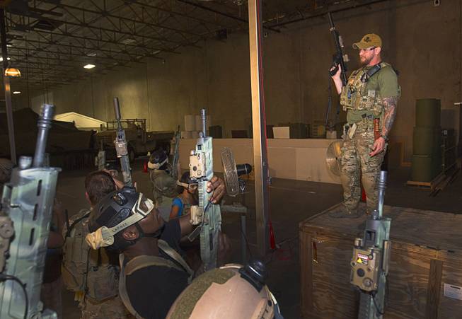 Team Leader Ragnarr gives weapon instructions before an operation at Adventure Combat Ops, 4375 S. Valley View Blvd., Monday, June 29, 2015. The zombie-apocalypse-combat experience opens on July 2.