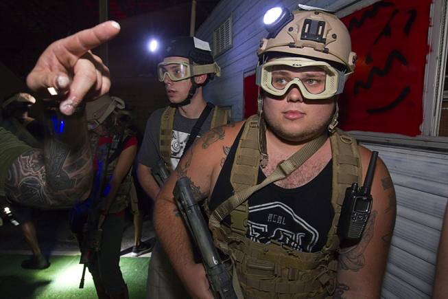 Brothers Nicholas , left, and Randy Newton head out during an operation at Adventure Combat Ops, 4375 S. Valley View Blvd., Monday, June 29, 2015. The zombie-apocalypse-combat experience opens on July 2.