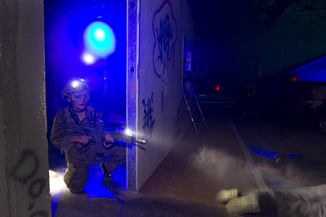 Vicki Gonzalez secures a door during an operation at Adventure Combat Ops, 4375 S. Valley View Blvd., Monday, June 29, 2015. The zombie-apocalypse-combat experience opens on July 2.