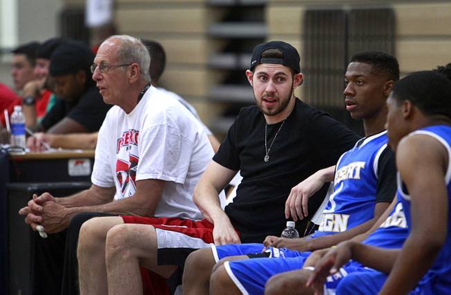 UNLV junior forward Ben Carter, center, talks to teammates on the bench during the Desert Reign Pro City League at Canarelli Middle School Monday, June 22, 2015. Carter has been out of action for several months because of a back injury. 