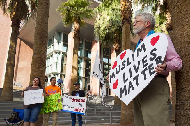 Anti-drone activist Fred Bialy, right, of El Cerrito, Calif. demonstrates in front of the Clark County Regional Justice Center in Las Vegas Tuesday, June 30, 2015. Bialy and other activists are facing misdemeanor charges in relation to a March 6, 2015 protest at Creech Air Force Base, about 45 miles northwest of Las Vegas.