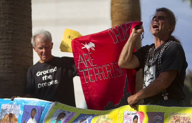 Anti-drone activists Dennis DuVall, left, of Prescott, Ariz. and Mauro Oliveira of Montgomery Creek, Calif. demonstrate in front of the Clark County Regional Justice Center in Las Vegas Tuesday, June 30, 2015. Many of the activists are facing misdemeanor charges in relation to a March 6, 2015 protest at Creech Air Force Base, about 45 miles northwest of Las Vegas.