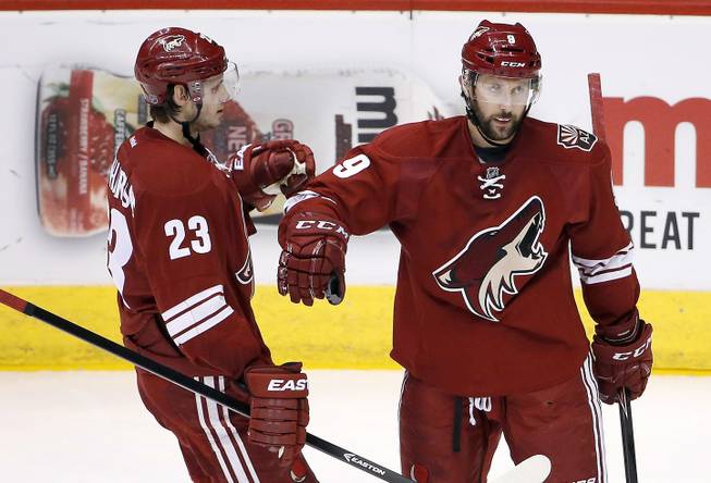 Arizona Coyotes' Sam Gagner (9) celebrates his goal against the Anaheim Ducks with teammate Oliver Ekman-Larsson (23), of Sweden, during the third period of an NHL hockey game Saturday, April 11, 2015, in Glendale, Ariz. The Ducks defeated the Coyotes 2-1. 