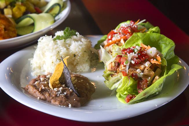 Chicken Lettuce Wraps with organic cilantro rice and pinto beans are displayed at El Dorado Cantina, 3025 Industrial Road, Wednesday July 1, 2015. The Mexican restaurant specializes in meals made with non-GMO, organic ingredients. The beef are grass-fed, the fish are farm-raised and the chicken are free-range, a representative said.