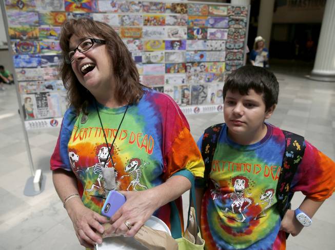 Rebecca Ostrega, from Oswego, Ill., talks about her devotion to the Grateful Dead as she and her son Jake, visit an exhibit dedicated to the band June 30 at the Field Museum in Chicago.