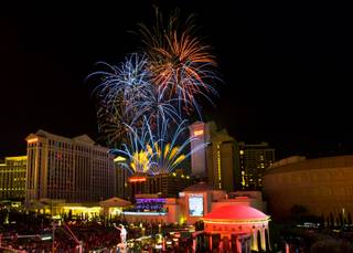 Fireworks amaze the crowds over Caesars Palace about the Las Vegas Strip as seen from the Vortex of The LINQ Hotel on Saturday, July 4, 2015.