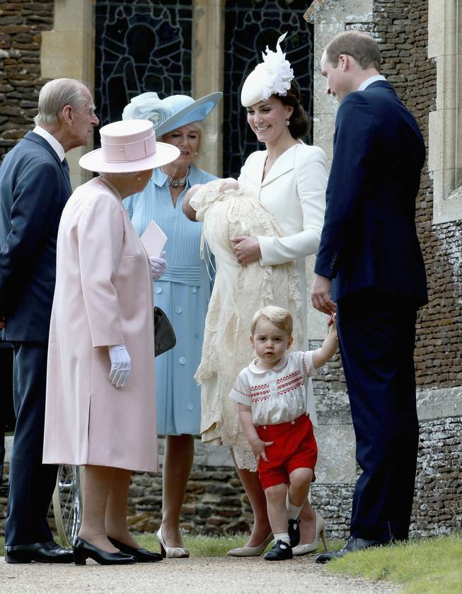 Kate, the Duchess of Cambridge, third from right, holding their daughter Princess Charlotte of Cambridge, stands next to Britain's Prince William, Duke of Cambridge, holding their son Prince George of Cambridge's hand, as they talk to Britain's Queen Elizabeth II, second from left, and Prince Phillip and Camilla, Duchess of Cornwall, after the Christening of Princess Charlotte of Cambridge at St. Mary Magdalene Church in Sandringham, England, on Sunday, July 5, 2015.