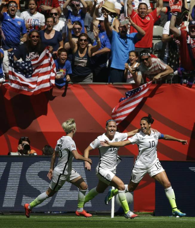 From left, the United States' Megan Rapinoe, Lauren Holiday and Carli Lloyd celebrate after Lloyd scored her second goal of the match against Japan during the first half of the FIFA Women's World Cup soccer championship in Vancouver, British Columbia, Canada, Sunday, July 5, 2015. The U.S. won 5-2.