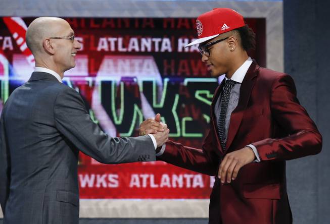 Kelly Oubre Jr., right, is greeted by NBA Commissioner Adam Silver after being selected 15th overall by the Atlanta Hawks during the NBA basketball draft, Thursday, June 25, 2015, in New York.