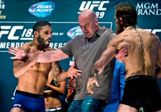 UFC 189 featherweight fighters Chad Mendes and Conor McGregor are separated by UFC President Dana White during their face-off following weigh-in at the MGM Grand Garden Arena in Las Vegas on Friday, July 10, 2015.   They will meet in an interim title fight. 