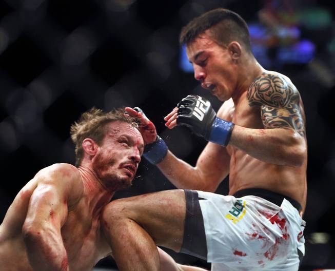 Brad Pickett takes a flying knee to the neck and chin by Thomas Almeida ending their UFC189 fight at the MGM Grand Garden Arena on Saturday, July 11, 2015.