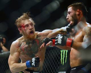 Interim featherweight title fighter Conor McGregor lands the finishing punch to the chin of Chad Mendes during their UFC189 fight at the MGM Grand Garden Arena on Saturday, July 11, 2015.