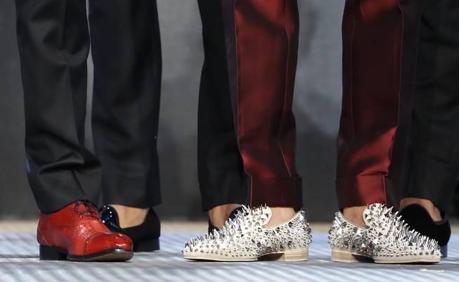 Kelly Oubre Jr. dons special shoes for the NBA basketball draft, Thursday, June 25, 2015, in New York.
