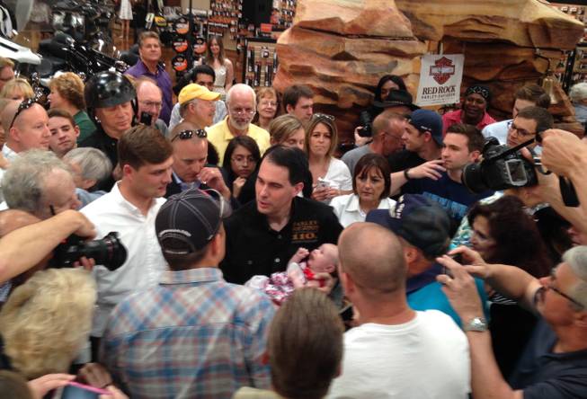 Republican presidential candidate and Wisconsin Gov. Scott Walker holds a baby during a campaign stop  Tuesday, July, 14, 2015, in Las Vegas.