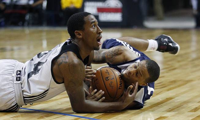 Brooklyn Nets’ Rondae Hollis-Jefferson, left, dives for the ball with New Orleans Pelicans’ Bryce Dejean-Jones during the first half of an NBA summer league basketball game Monday, July 13, 2015, in Las Vegas. 