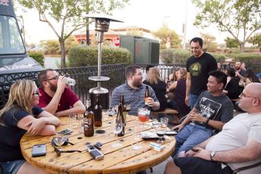 Welcome to Khoury’s: Issa and his customers talk beer on the patio during a recent Wednesday night event.