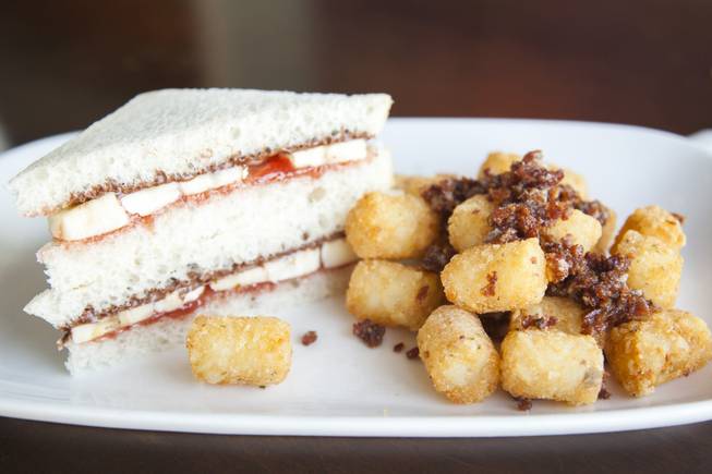 The "Little Elvis" at Truffles N Bacon Cafe restaurant located in Henderson, NV, is made up of nutella, banana, and grape jelly and is served with tater tots topped off with their award winning bacon jam as seen on Thursday, July 17, 2015.
