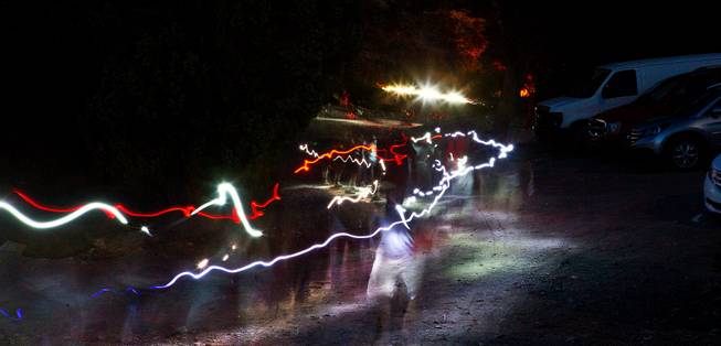 Souts make their way along a path by flashlight up to where members of the Las Vegas Astronomical Society are waiting with telescopes atop a rise at the Boy Scout camp on Mt. Potosi on Tuesday, June 23, 2015.