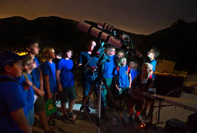 Las Vegas Astronomical Society member Rob Lambert instructs Boy Scouts as to what they will hopefully see in the telescopes at their camp on Mt. Potosi on Tuesday, June 23, 2015.
