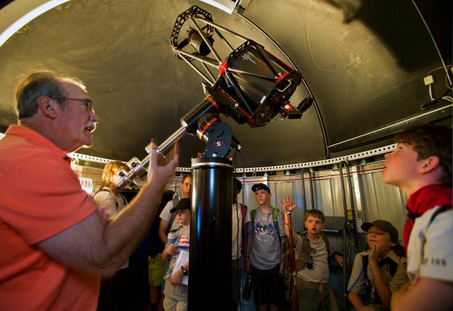 Las Vegas Astronomical Society member Jim Gianoulakis shows off a telescope and talks about its capabilities to Boy Scouts at their camp on Mt. Potosi on Tuesday, June 23, 2015.