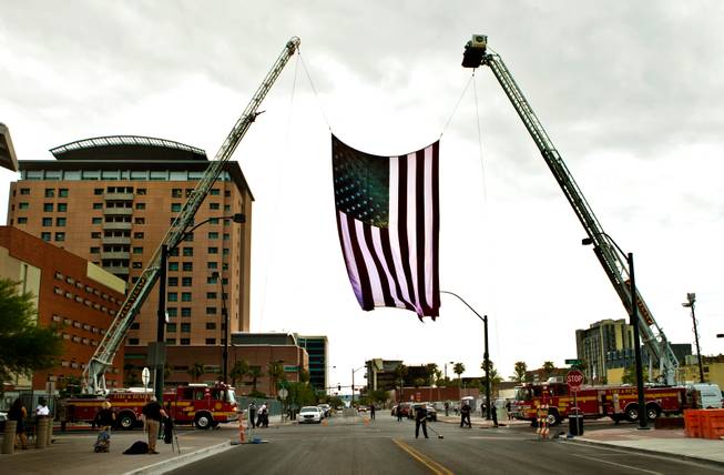 Las Vegas Firefighters erect a large American flag near City Hall for the 2015 Patriot Tour making a stop with over 50 motorcycles in line on Monday, July 20, 2015.