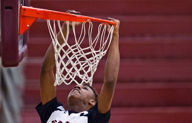 Andre Rafus (7) from Team Melo hangs on the rim after missing a dunk during the Bigfoot Hoops Las Vegas Classic at Eldorado High School on Thursday, July 23, 2015.