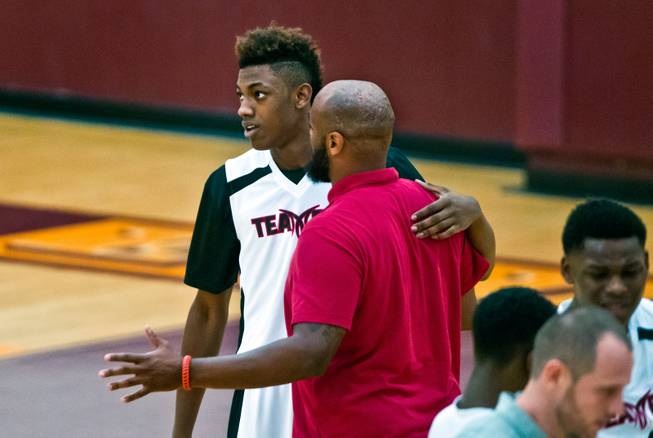 Andre Rafus (7) from Team Melo listens to his coach during the Bigfoot Hoops Las Vegas Classic at Eldorado High School on Thursday, July 23, 2015.