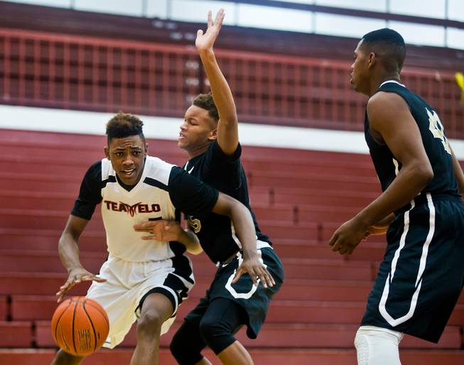 Andre Rafus (7) of Team Melo navigates around an EP Elite defender during the Bigfoot Hoops Las Vegas Classic at Eldorado High School on Thursday, July 23, 2015.
