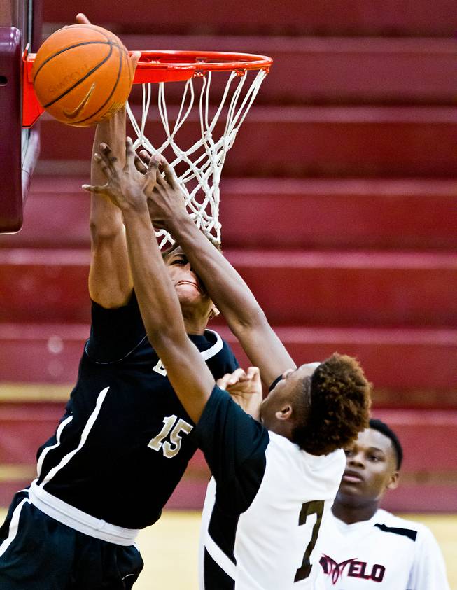 Andre Rafus (7) of Team Melo gets in the face of an EP Elite player under the basket during the Bigfoot Hoops Las Vegas Classic at Eldorado High School on Thursday, July 23, 2015.