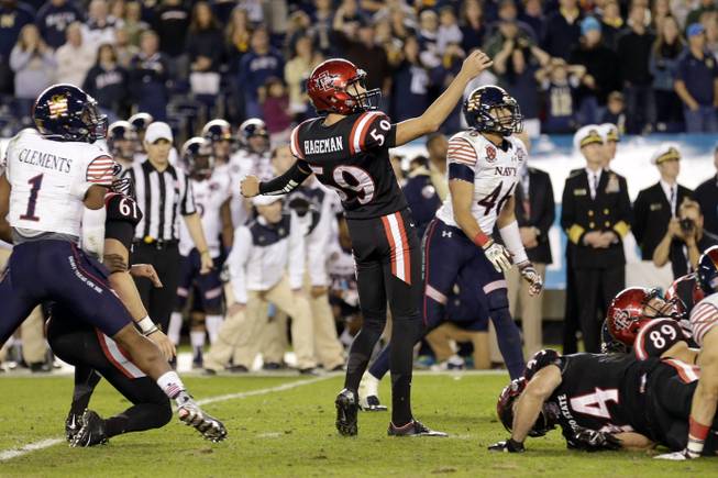 San Diego State place kicker Donny Hageman (59) watches his missed field goal attempt in the final seconds of the game as Navy cornerback Brendon Clements (1) and Navy linebacker Chris Johnson (46) look on during the Poinsettia Bowl NCAA college football game Tuesday, Dec. 23, 2014, in San Diego. Navy won 17-16.