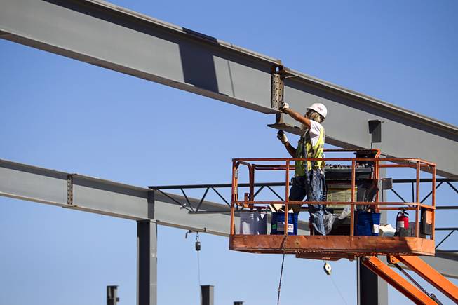 An ironworker connects steel girders as construction continues on the Ikea Las Vegas store at Durango Drive and Sunset Road Tuesday, July 28, 2015. The store is expected to open in the summer of 2016.