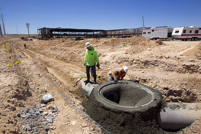 Workers build a storm drain manhole by the Ikea Las Vegas construction site at Durango Drive and Sunset Road Tuesday, July 28, 2015. The store is expected to open in the summer of 2016.