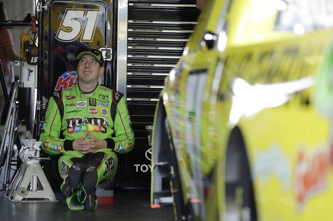 Kyle Busch waits in the garage for the start of a practice session for Saturday's NASCAR truck series Pocono Mountains 150 auto race, Friday, July 31, 2015, in Long Pond, Pa.