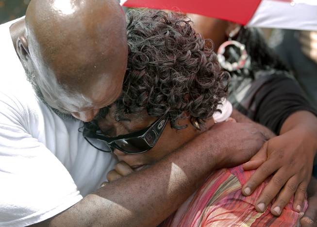 Alfred Smalls comforts Judy Scott on Thursday, July 9, 2015, at the site in North Charleston, S.C., where her son, Walter, was shot and killed by North Charleston police Officer Michael Slager.